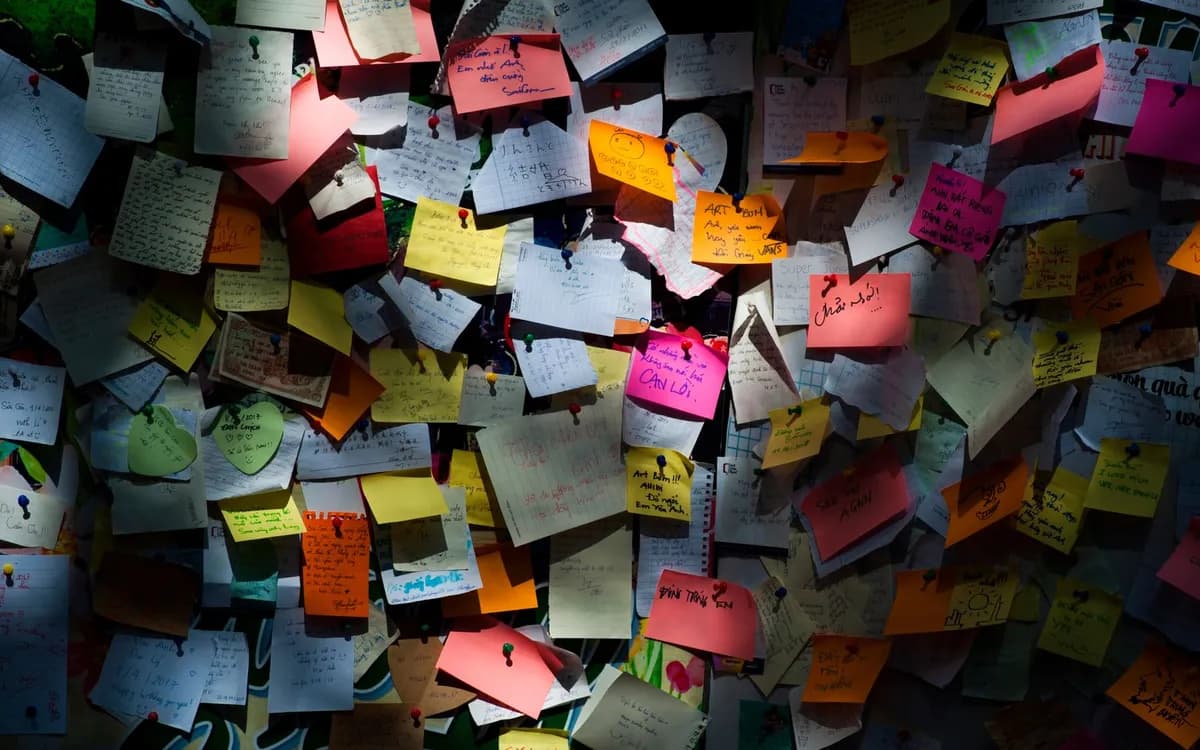 Parede cheia de post-its com tarefas acumuladas